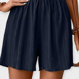 Pantalons Curts Elegants amb Plecs
